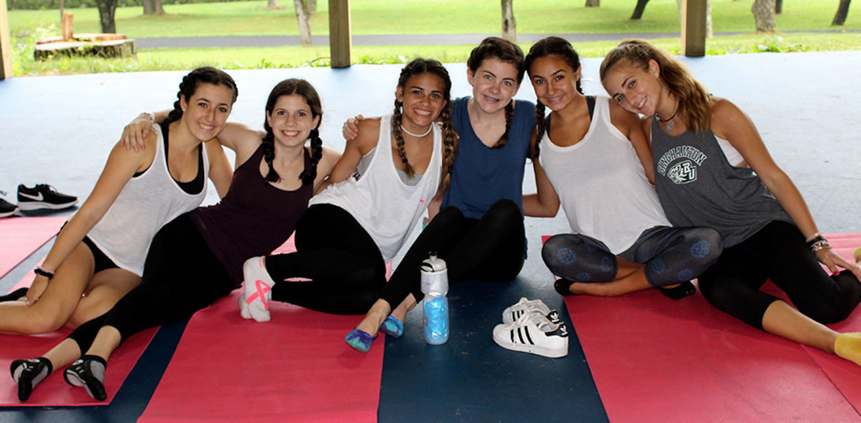 Teen girls sitting on yoga mats